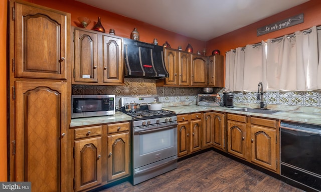 2212 S Bouvier St, Philadelphia, PA 19145 - kitchen featuring stainless steel appliances, extractor fan, light countertops, brown cabinets, and dark wood-type flooring
