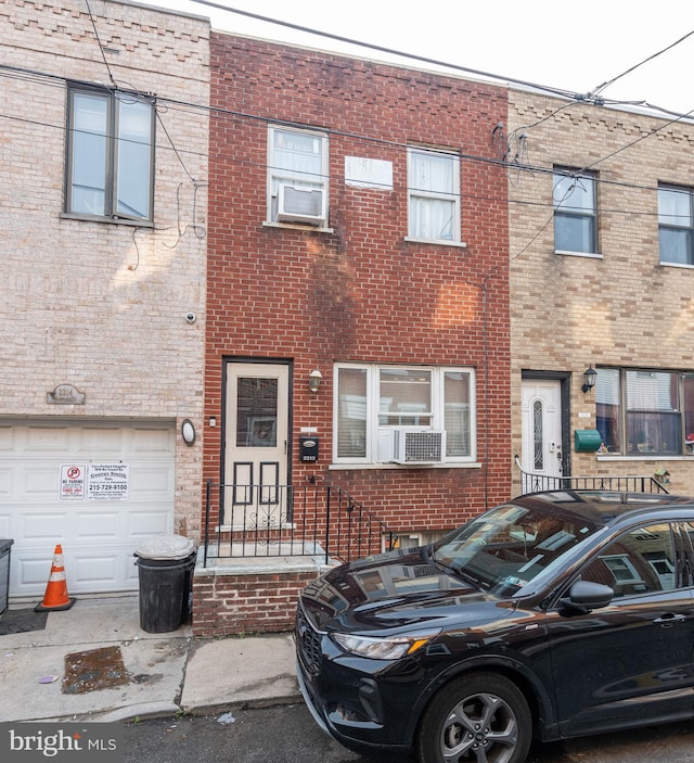 2212 S Bouvier St, Philadelphia, PA 19145 - multi unit property featuring brick siding, a garage, and cooling unit