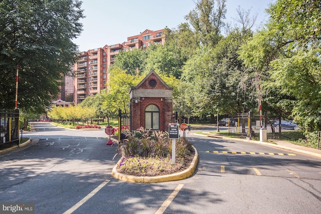 2230 George C Marshall Dr Unit 512, Falls Church, VA 22043 - view of asphalt road with curbs, a gated entry, and traffic signs
