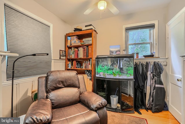 3702 Kingwood Sq, Baltimore, MD 21215 - living area with a ceiling fan, wood finished floors, and a wainscoted wall