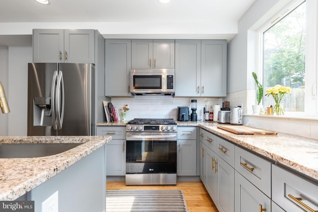 1229 S Bucknell St, Philadelphia, PA 19146 - kitchen featuring stainless steel appliances, gray cabinets, light stone counters, and recessed lighting
