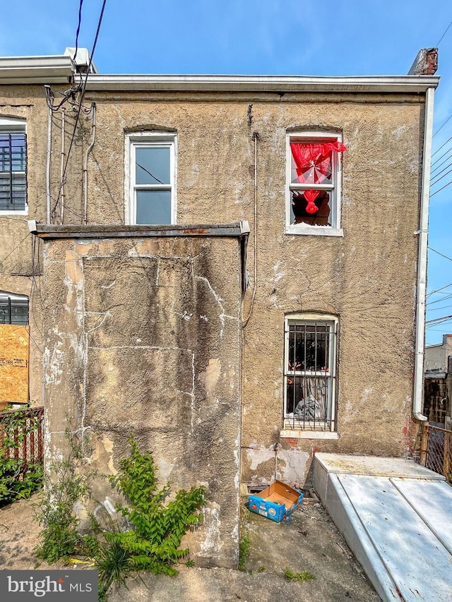 3601 9th St, Baltimore, MD 21225 - rear view of property with stucco siding
