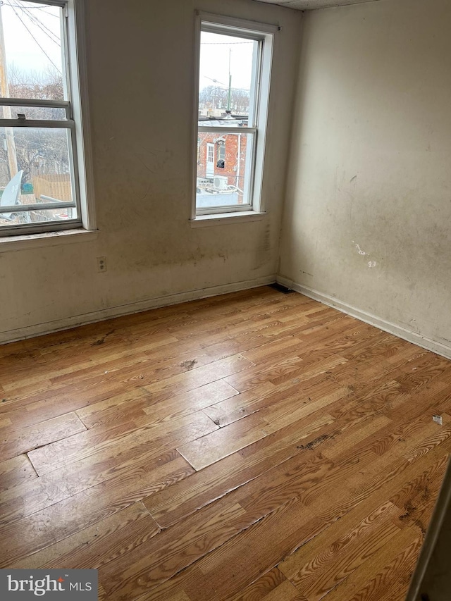 3601 9th St, Baltimore, MD 21225 - spare room featuring light wood-style flooring and plenty of natural light