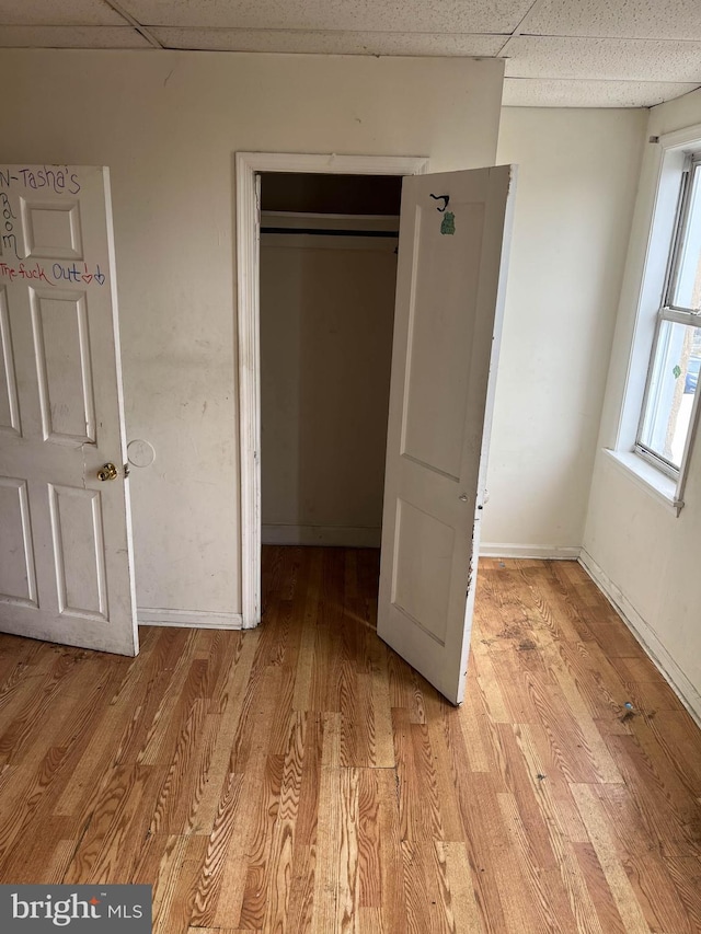 3601 9th St, Baltimore, MD 21225 - unfurnished bedroom featuring a drop ceiling, light wood-style floors, and a closet