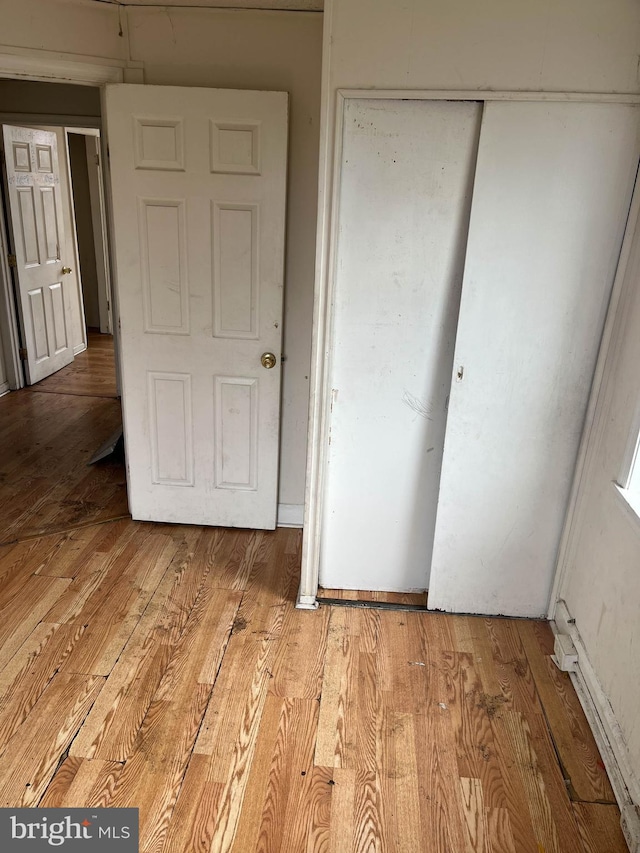 3601 9th St, Baltimore, MD 21225 - unfurnished bedroom featuring a closet and light wood-style flooring