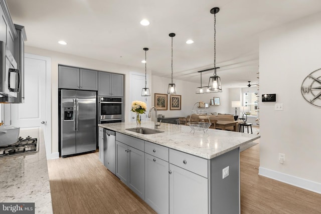 1210 Hickory Hill Cir, Arnold, MD 21012 - kitchen featuring appliances with stainless steel finishes, gray cabinetry, recessed lighting, light wood finished floors, and light stone countertops