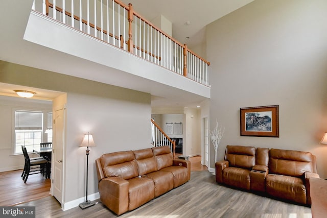 223 Fitzgerald St, Gerrardstown, WV 25420 - living area featuring wood finished floors, a towering ceiling, and stairs