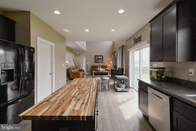 223 Fitzgerald St, Gerrardstown, WV 25420 - kitchen with stainless steel dishwasher, black fridge with ice dispenser, wooden counters, wood finished floors, and open floor plan