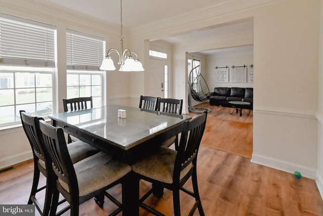 223 Fitzgerald St, Gerrardstown, WV 25420 - dining area featuring healthy amount of natural light, a chandelier, light wood finished floors, and ornamental molding