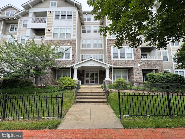 12824 Clarksburg Square Rd Unit 406, Clarksburg, MD 20871 - view of building exterior featuring a fenced front yard