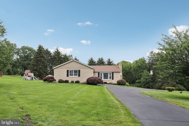 611 Hillcrest Dr, Perkasie, PA 18944 - ranch-style home featuring a playground, a front yard, and a chimney