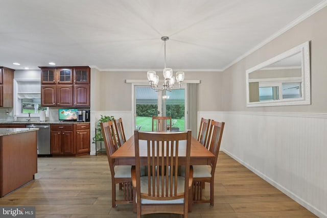 611 Hillcrest Dr, Perkasie, PA 18944 - dining space with a chandelier, a wainscoted wall, healthy amount of natural light, light wood finished floors, and crown molding