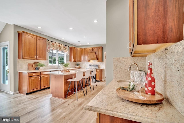 14 Canaday Ct, Belle Mead, NJ 08502 - kitchen with a kitchen bar, tasteful backsplash, a center island, light wood-style floors, and recessed lighting