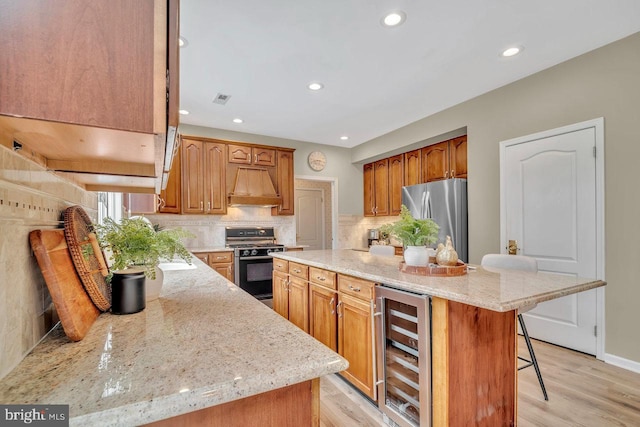 14 Canaday Ct, Belle Mead, NJ 08502 - kitchen with wine cooler, freestanding refrigerator, range with gas stovetop, custom exhaust hood, and a kitchen bar