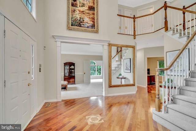 14 Canaday Ct, Belle Mead, NJ 08502 - entryway featuring a high ceiling, stairs, wood finished floors, and ornamental molding