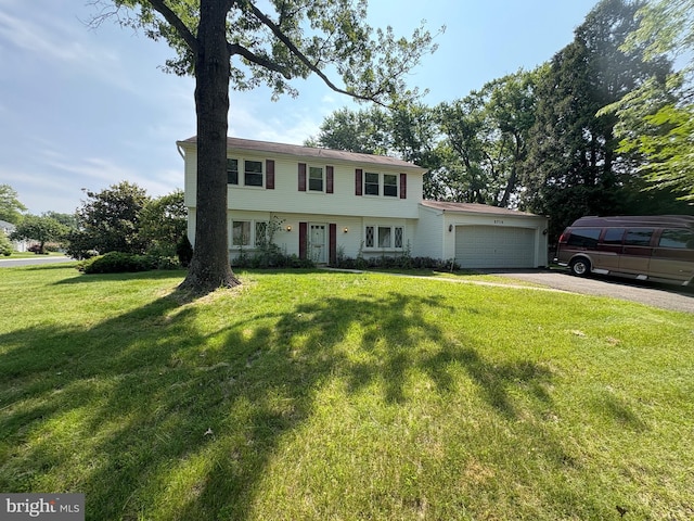 2713 Federal Ln, Bowie, MD 20715 - colonial inspired home with asphalt driveway, an attached garage, and a front lawn