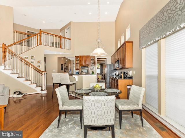 10600 Edwardian Ln, New Market, MD 21774 - dining room with wood finished floors, a towering ceiling, and stairway