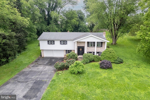301 N Lynbrook Dr N, York, PA 17402 - raised ranch featuring asphalt driveway, an attached garage, brick siding, and a front lawn