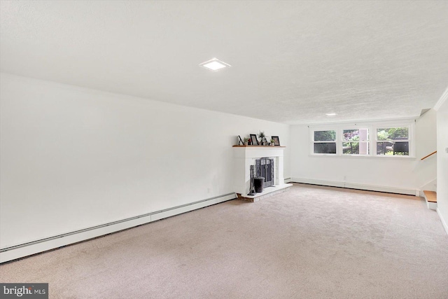 301 N Lynbrook Dr N, York, PA 17402 - unfurnished living room with a baseboard radiator, a fireplace with raised hearth, carpet flooring, stairway, and a textured ceiling