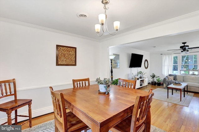 301 N Lynbrook Dr N, York, PA 17402 - dining area featuring a baseboard heating unit, light wood finished floors, crown molding, a chandelier, and a ceiling fan