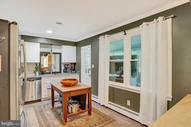 301 N Lynbrook Dr N, York, PA 17402 - kitchen with stainless steel appliances, light countertops, white cabinets, a baseboard radiator, and light tile patterned floors