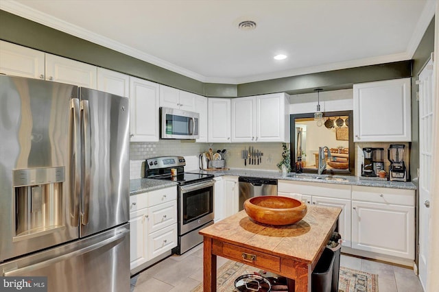 301 N Lynbrook Dr N, York, PA 17402 - kitchen with appliances with stainless steel finishes, light tile patterned floors, white cabinetry, ornamental molding, and recessed lighting