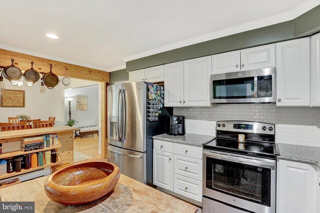 301 N Lynbrook Dr N, York, PA 17402 - kitchen with appliances with stainless steel finishes, white cabinetry, crown molding, backsplash, and light stone counters