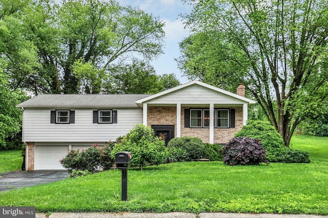 301 N Lynbrook Dr N, York, PA 17402 - split level home with brick siding, driveway, a front lawn, and an attached garage