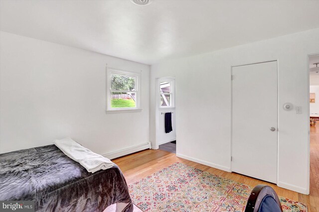 301 N Lynbrook Dr N, York, PA 17402 - bedroom with a baseboard heating unit and light wood-type flooring