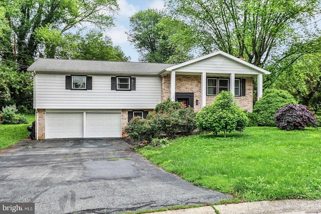 301 N Lynbrook Dr N, York, PA 17402 - bi-level home featuring brick siding, an attached garage, and asphalt driveway