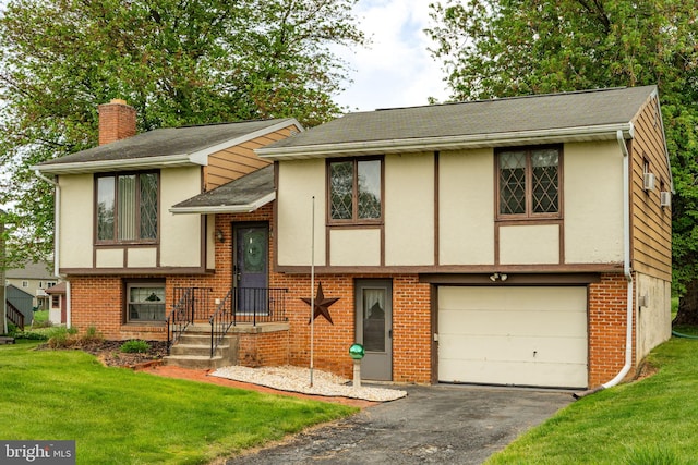 1721 Pioneer Rd, Lancaster, PA 17602 - view of front facade with a chimney, asphalt driveway, a garage, a front lawn, and stucco siding