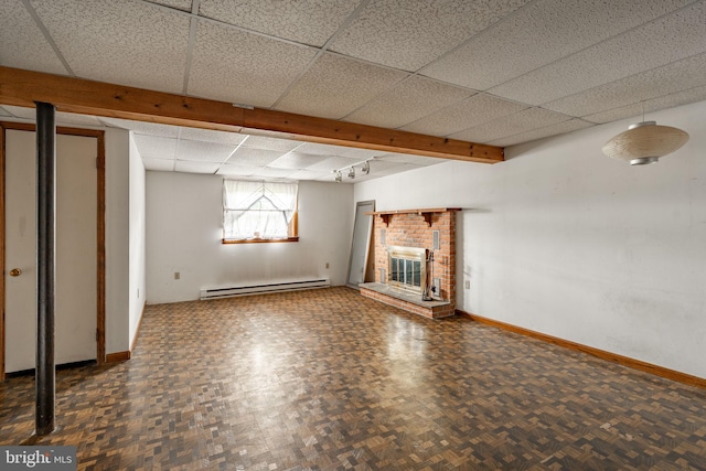 1721 Pioneer Rd, Lancaster, PA 17602 - basement with a baseboard heating unit, a paneled ceiling, and a brick fireplace