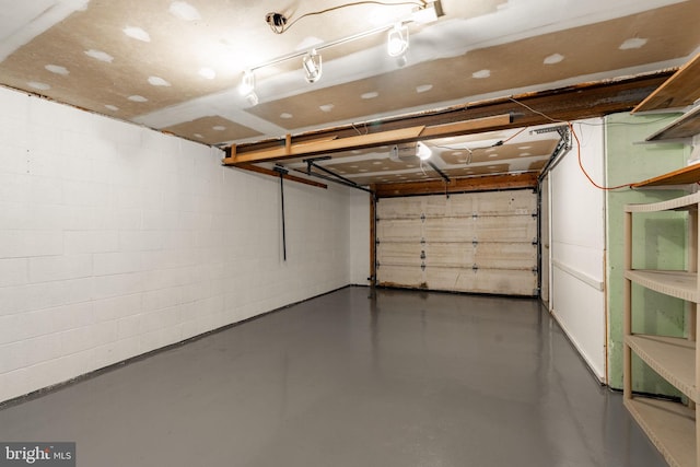 1721 Pioneer Rd, Lancaster, PA 17602 - garage featuring a garage door opener and concrete block wall