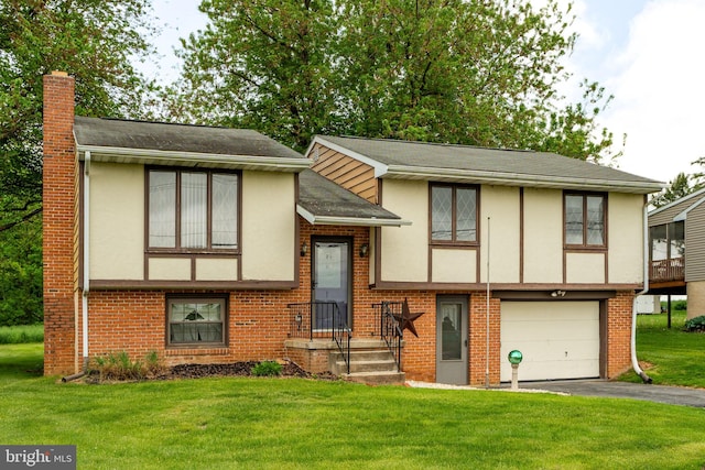1721 Pioneer Rd, Lancaster, PA 17602 - view of front of home with stucco siding, a chimney, an attached garage, driveway, and brick siding
