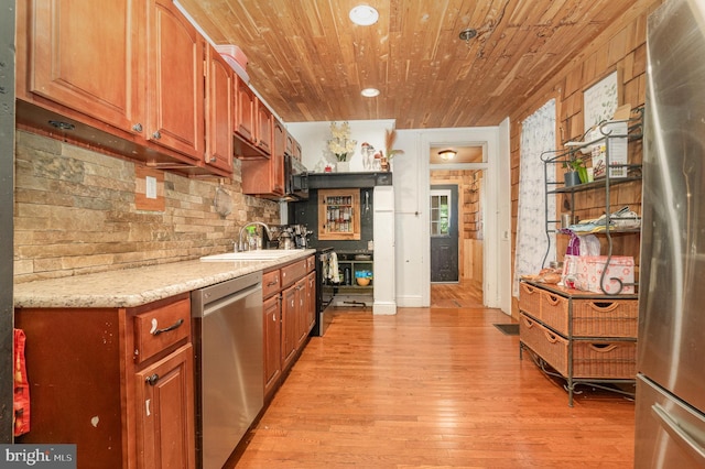 1015 N Duke St, York, PA 17404 - kitchen featuring stainless steel appliances, light wood-style floors, wood ceiling, brown cabinets, and decorative backsplash
