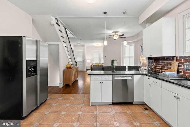 745 Gresham Pl NW, Washington, DC 20001 - kitchen with appliances with stainless steel finishes, a peninsula, ceiling fan, and white cabinetry