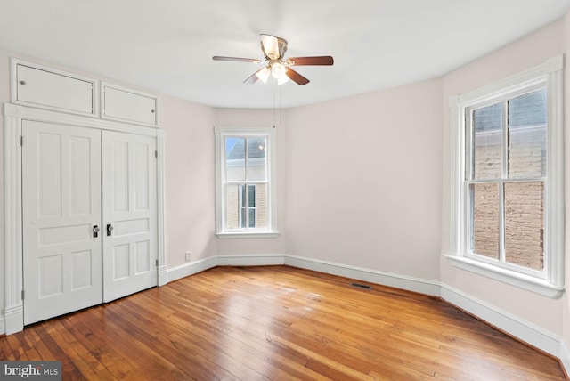 745 Gresham Pl NW, Washington, DC 20001 - unfurnished bedroom featuring light wood-type flooring, a closet, and a ceiling fan