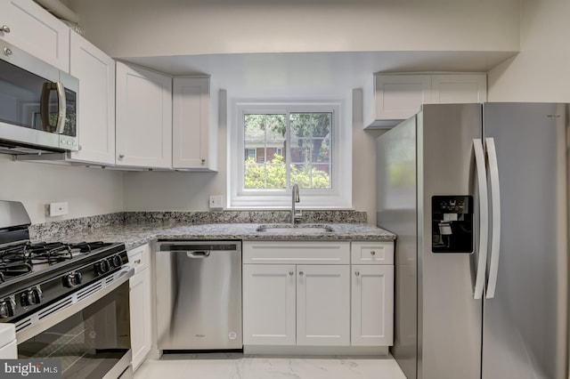 1628 Mount Eagle Pl, Alexandria, VA 22302 - kitchen featuring stainless steel appliances, light marble finish floors, light stone countertops, and white cabinetry
