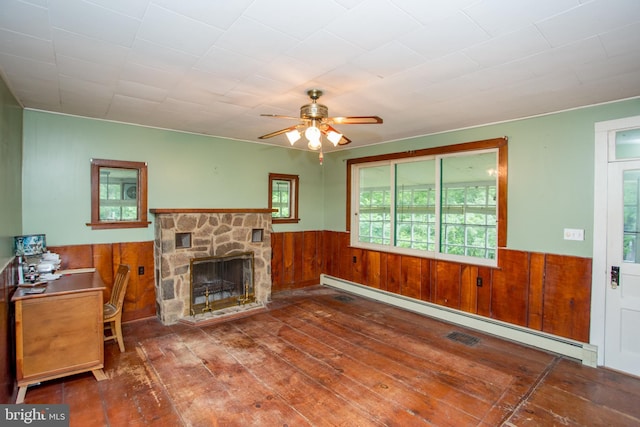 35 Strimples Mill Rd, Stockton, NJ 08559 - living room featuring baseboard heating, a wainscoted wall, wooden walls, hardwood / wood-style floors, and a ceiling fan