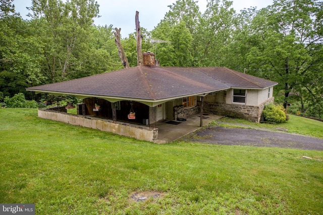 35 Strimples Mill Rd, Stockton, NJ 08559 - view of front of house with a front yard, a chimney, stone siding, and a shingled roof