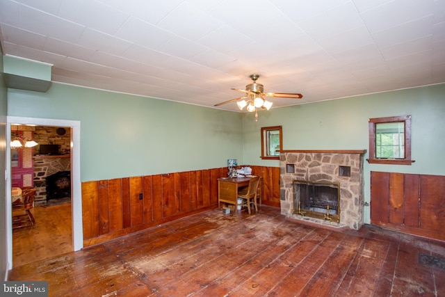 35 Strimples Mill Rd, Stockton, NJ 08559 - living area with a stone fireplace, hardwood / wood-style floors, a wainscoted wall, a ceiling fan, and wooden walls