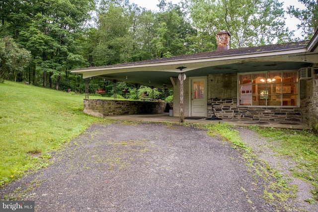 35 Strimples Mill Rd, Stockton, NJ 08559 - view of front of home with a chimney, stone siding, a front yard, and asphalt driveway