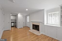 3241 N St NW Unit 1, Washington, DC 20007 - unfurnished living room featuring a fireplace, wood finished floors, and recessed lighting