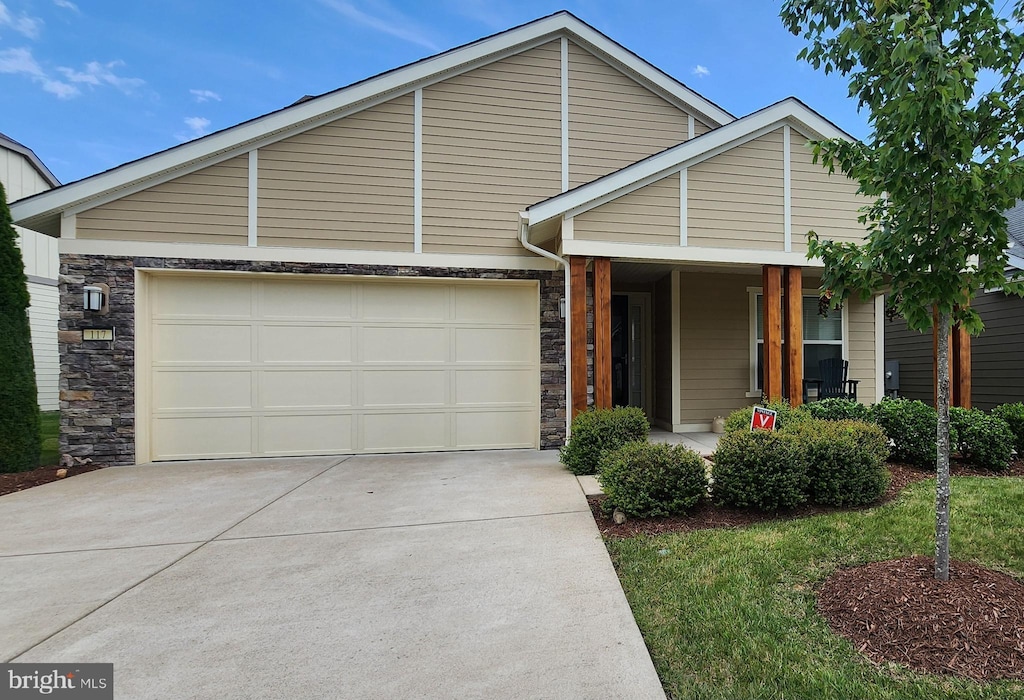 117 Gadwell Ln, Lake Frederick, VA 22630 - mid-century inspired home featuring stone siding, concrete driveway, a garage, and covered porch