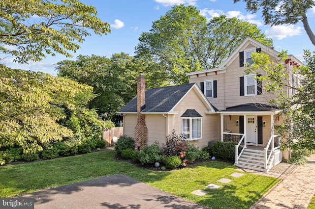 127 Fowler Ave, Haddonfield, NJ 08033 - view of front of home with covered porch, a chimney, a front yard, and roof with shingles