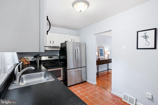 127 Fowler Ave, Haddonfield, NJ 08033 - kitchen featuring under cabinet range hood, appliances with stainless steel finishes, dark countertops, white cabinets, and tile patterned flooring