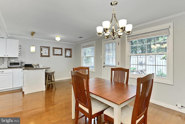 1581 Poplar Grove Dr, Reston, VA 20194 - dining room with a chandelier, plenty of natural light, light wood-type flooring, and crown molding