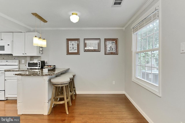 1581 Poplar Grove Dr, Reston, VA 20194 - kitchen featuring white appliances, white cabinetry, ornamental molding, and light wood-type flooring