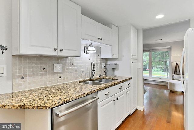 1581 Poplar Grove Dr, Reston, VA 20194 - kitchen featuring stainless steel dishwasher, backsplash, wood finished floors, and white cabinets