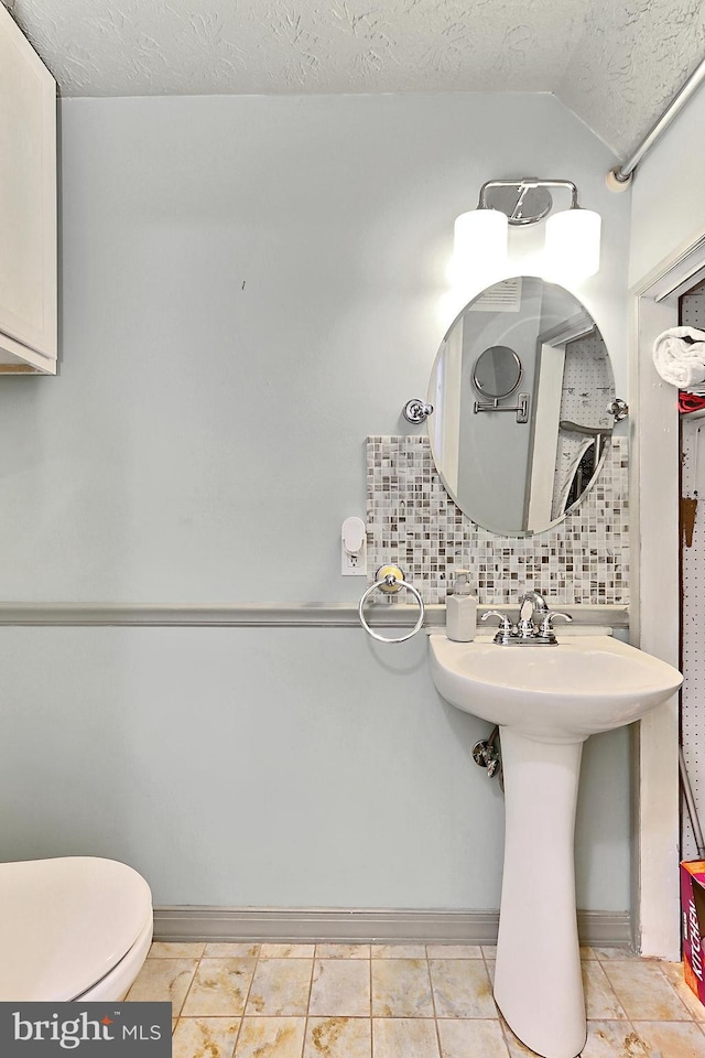 1581 Poplar Grove Dr, Reston, VA 20194 - bathroom with tasteful backsplash, a textured ceiling, tile patterned flooring, and vaulted ceiling